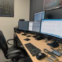 A programmer's desk with multiple screens and code